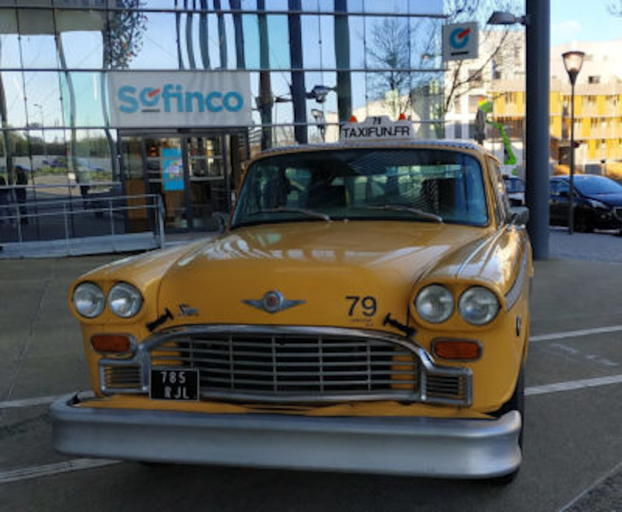 new york taxi yellow cab checker marathon in front of the sofinco headquarters